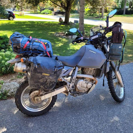 Photo of waterproof backpack secured to the back of motorcycle